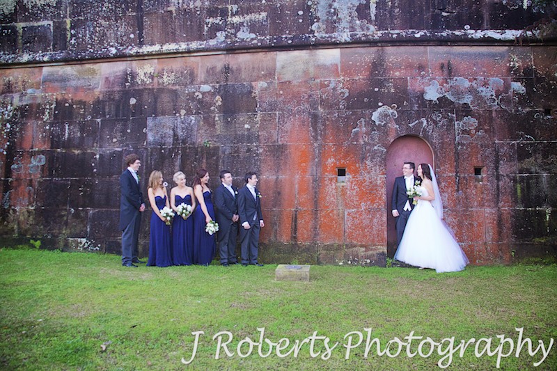 Bridal party in front of orange lichen historic wall at Gunners' Barracks Mosman - wedding photography sydney